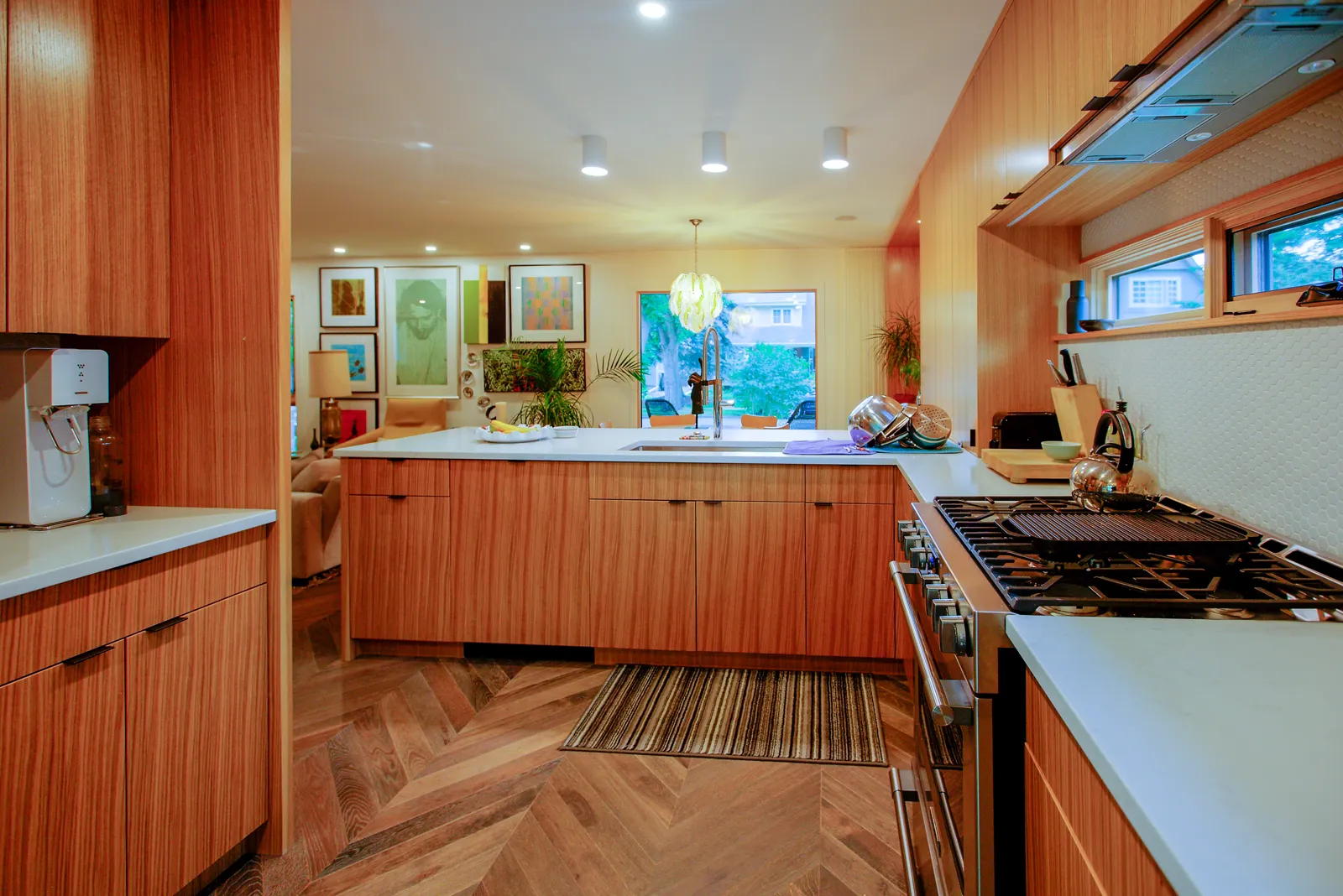 Mount Royal kitchen after renovation — warm wood cabinetry, white quartz counters and a gas range, Calgary