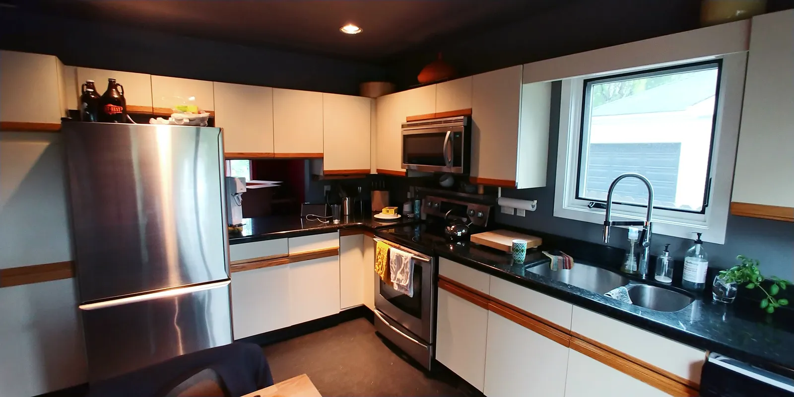 Mount Royal kitchen before renovation — cramped layout with a dark painted ceiling and laminate cabinets